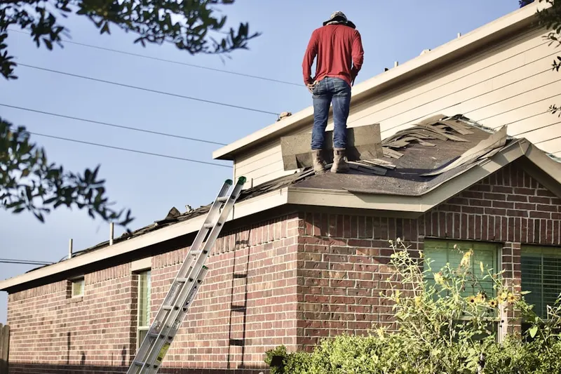 Professional roofer working on a residential roof in Groveton Heights